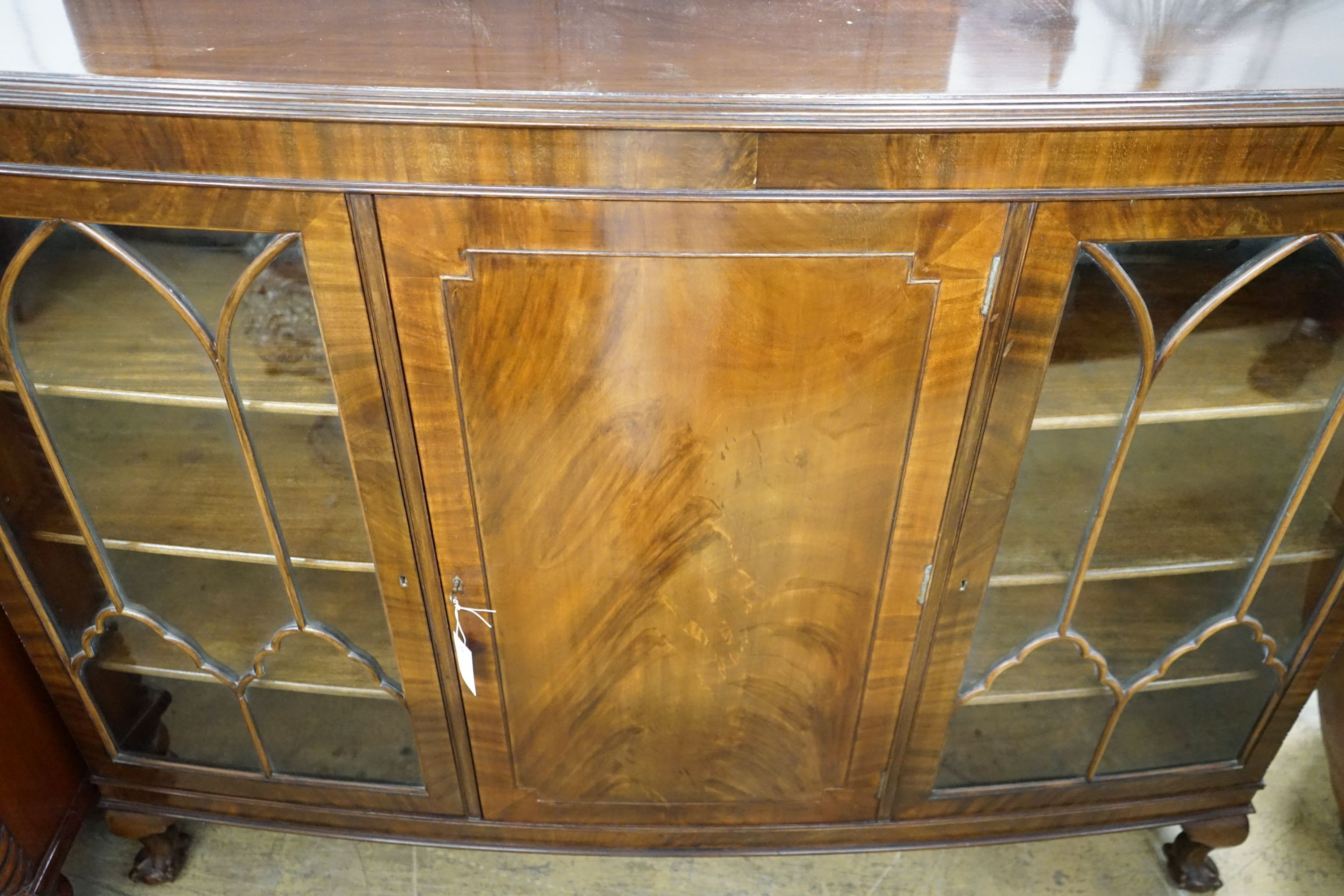 A 1920's mahogany bowfont bookcase, width 152cm, depth 39cm, height 116cm